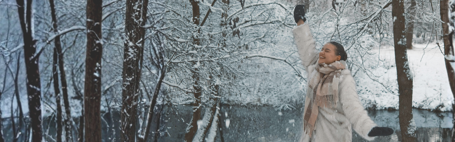 happy woman in snowy forest